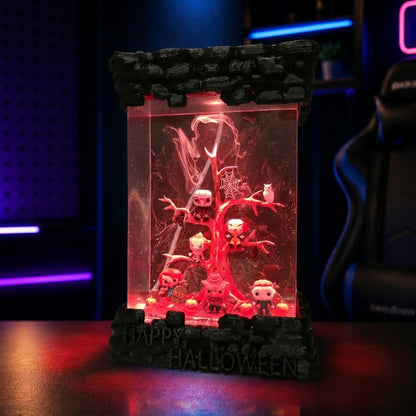 Close-up of handmade horror character miniatures inside a crystal-clear Halloween epoxy resin lamp