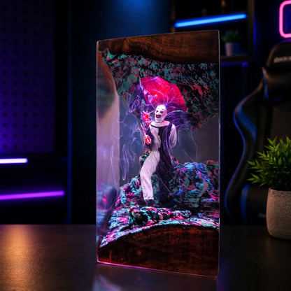 Horror clown epoxy resin lamp glowing with eerie LED light in a dark room