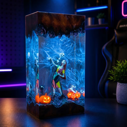 A rectangular resin lamp featuring a Jack Skellington and Sally design inspired by The Nightmare Before Christmas, set on a dark table with glowing jack-o'-lanterns and a spooky blue background.